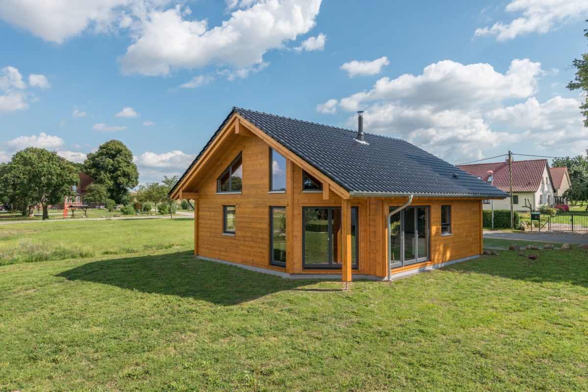 Musterhaus Wismarbucht - Ein Haus inmitten einer üppigen grünen Wiese - Holzhaus