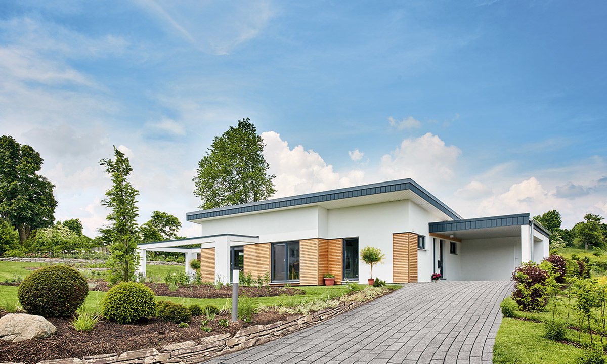 Nivelo - Ein Haus mit Bäumen im Hintergrund - Fingerhut Haus GmbH & Co. KG