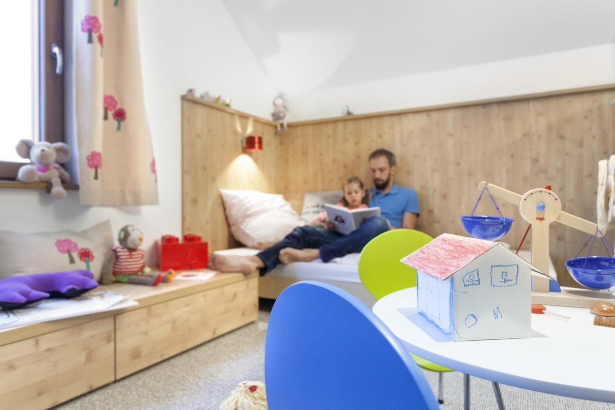 Schwörer Haus Musterhaus Villingen-Schwenningen - Eine Person, die auf einem Bett sitzt - Kinderzimmer