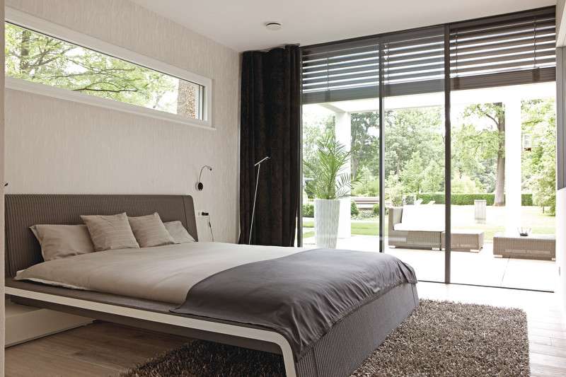 Ebenleben Rheinau-Linx - Ein Schlafzimmer mit einem Bett und einem großen Fenster - WeberHaus