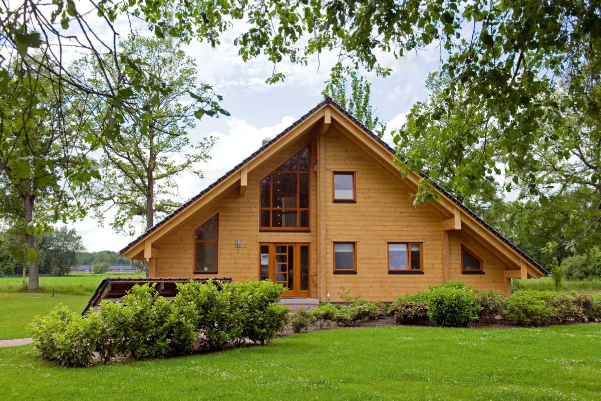 Holzhaus Barkhof - Ein großes Backsteingebäude mit Gras vor einem Haus - Holzhaus