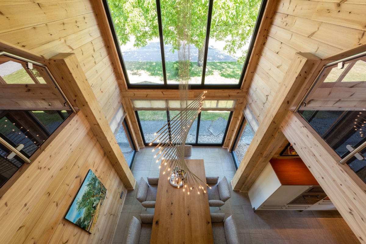 Musterhaus Hohenlohe - Eine Holzbank sitzt neben einem Kamin - Interior Design Services