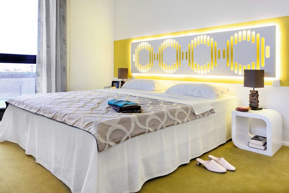 Musterhaus Köln - Ein großes weißes Bett in einem Raum sitzen - Schlafzimmer
