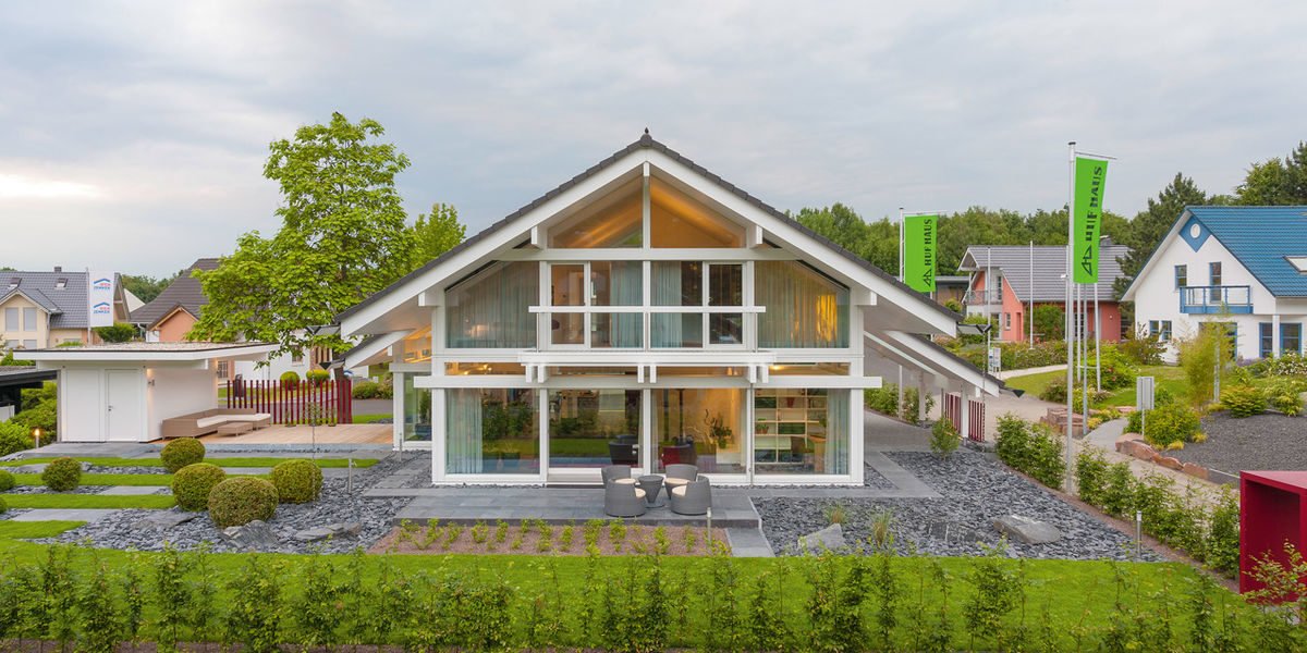 HUF HAUS Musterhaus Frankfurt - Ein Haus mit Bäumen im Hintergrund - Huf Haus