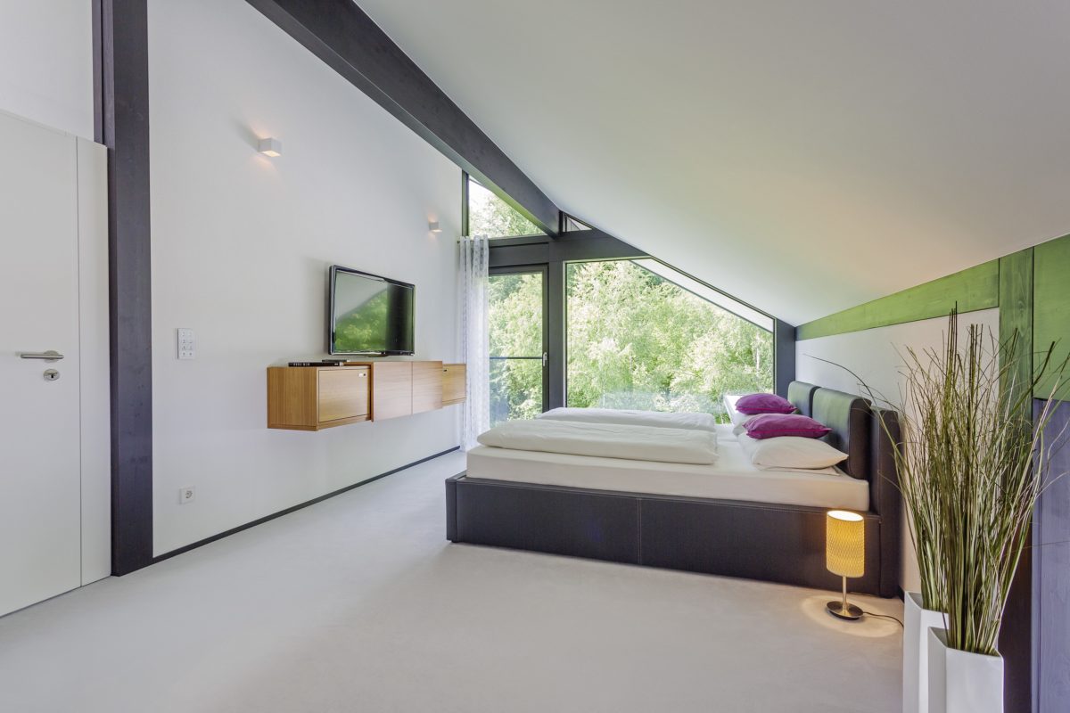 HUF HAUS MODUM 7 - Ein Schlafzimmer mit einem Bett in einem Raum - Interior Design Services