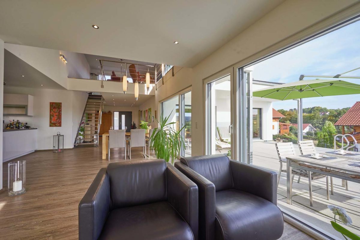 Kundenhaus Freilinger - Ein Wohnzimmer mit Möbeln und einem großen Fenster - Interior Design Services