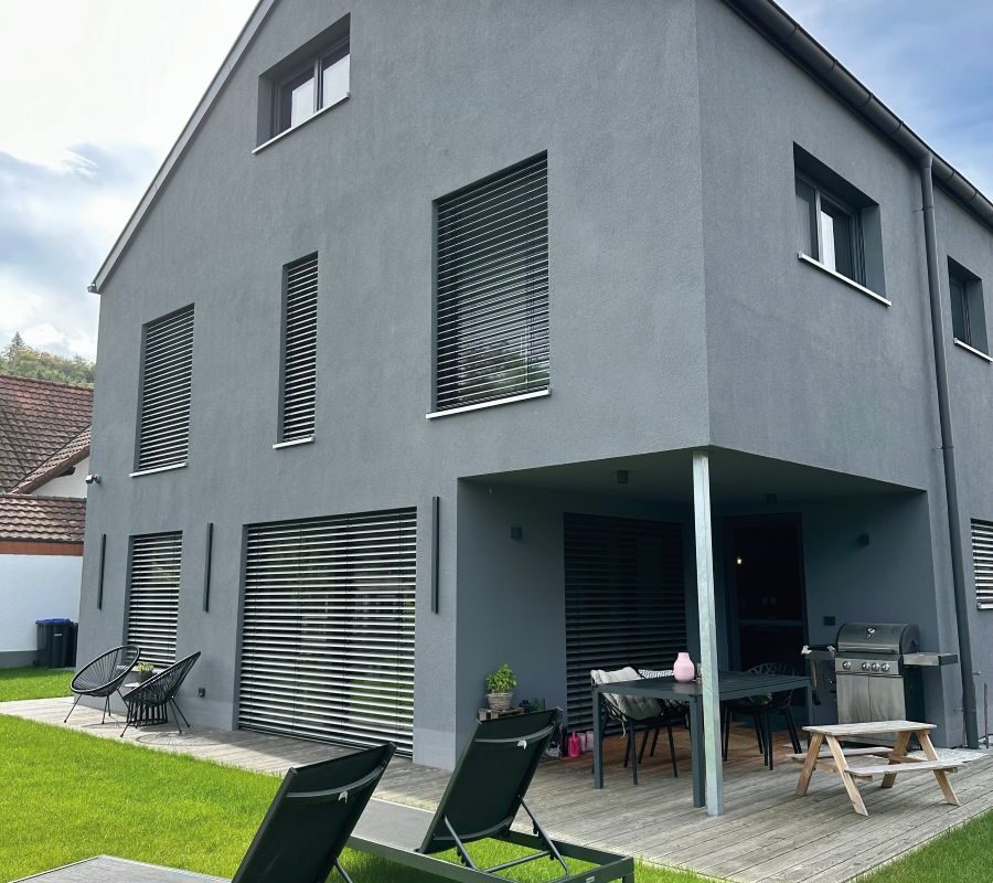 MyMassivhaus Hanghaus Brand Außen Ansicht Garten und Terrasse